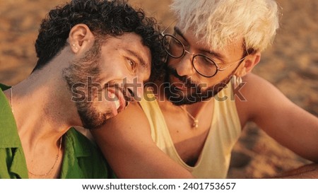 Romantic moments, homosexual couple enjoying intercourse with each other while sitting on the beach at dawn