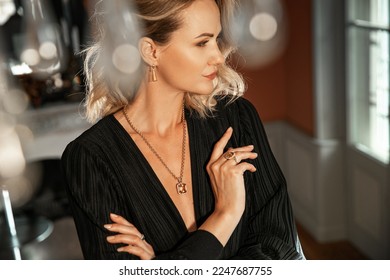 Romantic portrait of a girl dressed in an elegant dress and expensive jewelry
