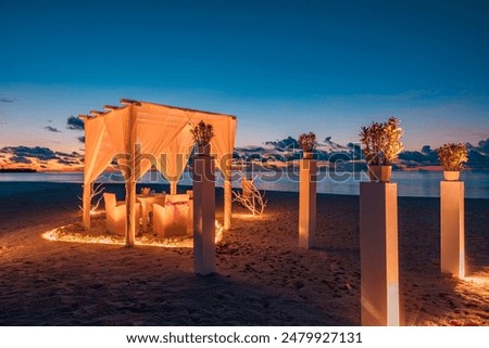 Romantic proposal sunset dinner. Candles white decoration pavilion, door close to sea sand beach. Love honeymoon anniversary dinner on tropical beach. Destination romance wedding, luxury couple travel