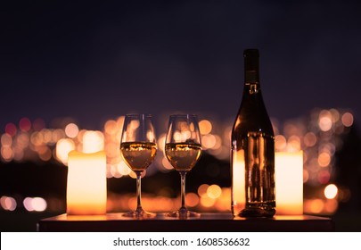 Romantic Relaxing Outdoor Setting With Wine And Beautiful City Views At Night. 