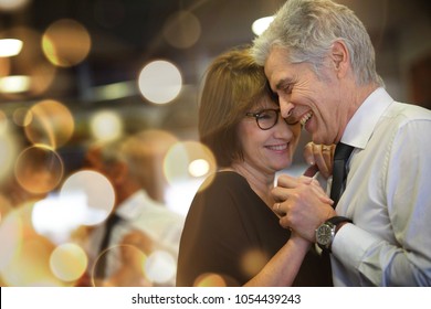Romantic Senior Couple Dancing Together At Dance Hall