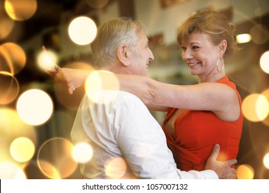 Romantic Senior Couple Dancing Together At Dance Hall