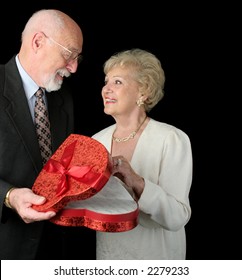 A Romantic Senior Couple On Valentines Day.  Black Background.