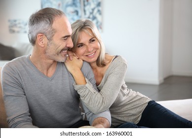 Romantic senior couple relaxing in couch 