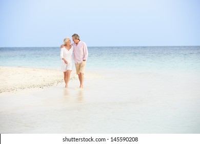 Romantic Senior Couple Walking On Beautiful Tropical Beach - Powered by Shutterstock