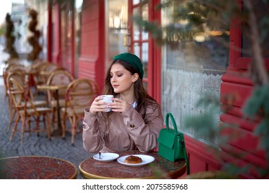 romantic sophisticated woman drinking coffee or cappuccino in a french cafe on street. romantic sophisticated girl sits at a table in pastry shop or bakery - Shutterstock ID 2075585968