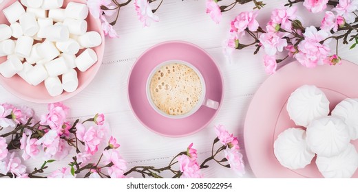 Romantic Spring Still Life. Coffee Cup With Marshmallow In The Morning For Breakfast. Cherry Blossom On White Wooden Background. Flat Lay. Pastel Pink Card. Food Background. Dessert With Floral Decor