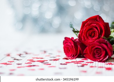 Romantic still life, red roses on white wooden background. Valentine's day concept.Soft focus