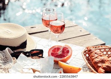 Romantic sunset dinner on the beach. Table honeymoon set for two with luxurious food, glasses of rose wine drinks in a restaurant with sea view. Summer love, romance date on vacation concept. - Powered by Shutterstock