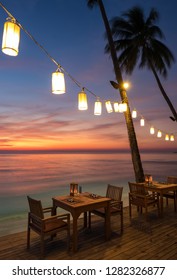 Romantic sunset on the shore of a tropical island, Koh Chang, Thailand. Outdoor cafe on the beach.