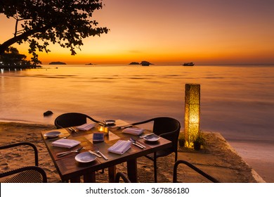 Romantic sunset on the shore of a tropical island. Cafe on the beach. Koh Chang. Thailand.
