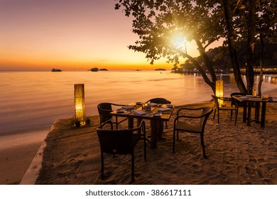 Romantic sunset on the shore of a tropical island. Cafe on the beach. Koh Chang. Thailand.