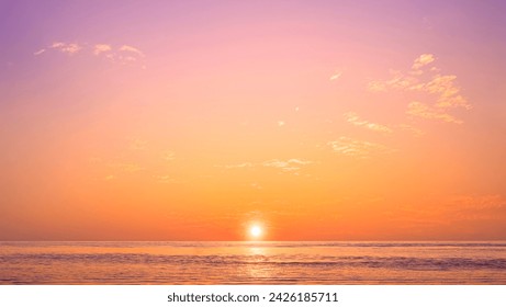 Romantic sunset sky background over sea with golden fluffy cloud on idyllic orange evening sky and sunlight reflection on water surface, beautiful nature tranquil seascape in minimal style - Powered by Shutterstock