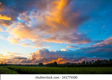 Romantic sunset sky with fluffy clouds.