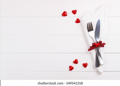 Romantic table setting on white wooden table.Valentine's day card template