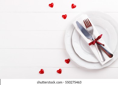 Romantic table setting on white wooden table.Valentine's day card template