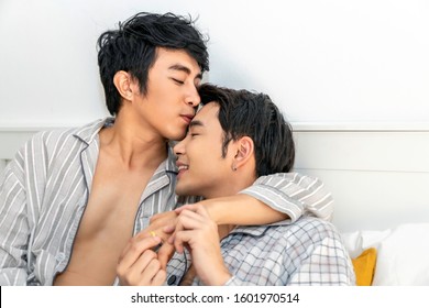 Romantic Time.Asian Homosexual Couple In Pajamas Hug And Kiss In The Bed.Concept LGBT Gay.