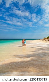 Romantic Tropical Island Getaway For Loving Retired Couple In Casual Clothing Walking Together On White Sandy Beach Bahamas