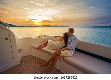 Romantic vacation . Beautiful couple looking in sunset from the yacht. - Shutterstock ID 1689298822