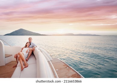 Romantic vacation and luxury travel. Young loving couple sitting on the sofa on the modern yacht deck. Sailing the sea. - Shutterstock ID 2116653866