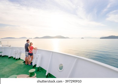 Romantic Vacation. Young Loving Couple Enjoying Sunset On Cruise Ship Deck. Sailing The Sea.