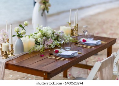 Romantic Wedding Table Top For Two 2 People Layout Table Spread No People Tropical Beach Location With Gold Cutlery And Scenic View Of Sunset On The Beach Soft Light