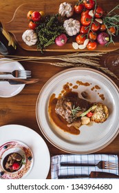 Romantic wine dinner table setting in top view angle with traditional Italian dishes and wine served at the restaurant in a luxury resort.
