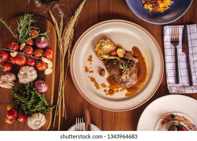 Romantic wine dinner table setting in top view angle with traditional Italian dishes and wine served at the restaurant in a luxury resort.