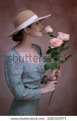 Similar – Woman makes festive bouquet with vase