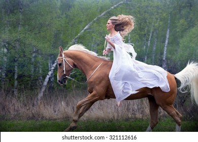 Romantic young beautiful girl galloping on a horse