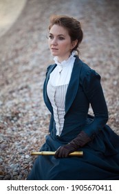 Romantic Young Beautiful Lady Wearing Victorian Dress Looking  At The Sea. Vintage Style. Steampunk Concept