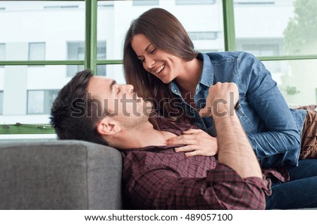 Romantic young couple at home fooling about