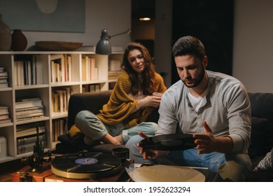 Romantic Young Couple Listening To A Music On Record Player At Home