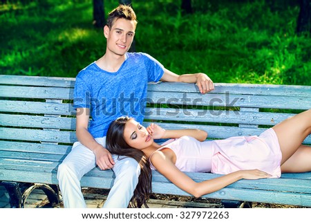 Romantic young couple in love having a rest together in the park. Romantic summer day. 