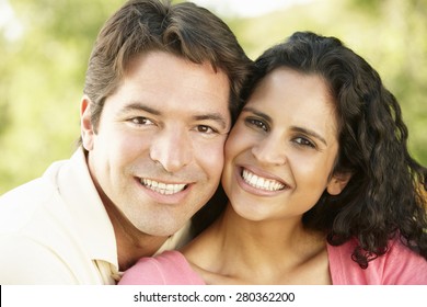 Romantic Young Hispanic Couple Relaxing In Park