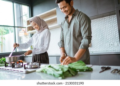 romantic young muslim couple have fun making food at home - Powered by Shutterstock