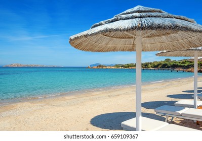 Romazzino Beach With White Umbrellas,emerald Coast Of Sardinia,Italy