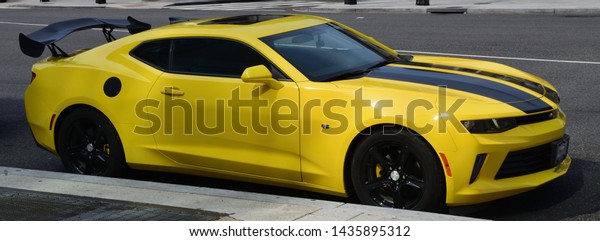 Rome - 06.26.2019 - Yellow Muscle Car parked in\
the street