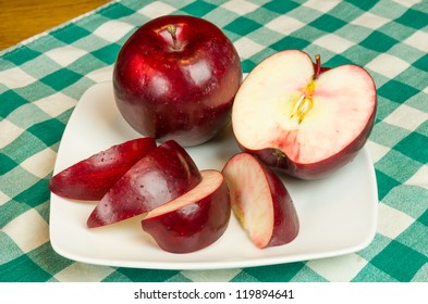 Rome Beauty Apple Sliced On White Plate