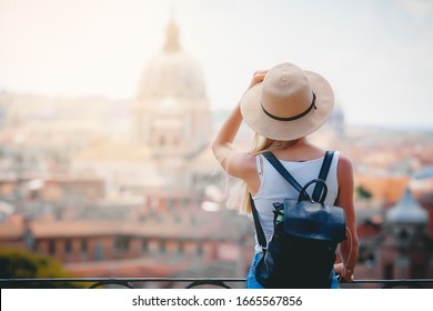 Rome Europe Italy travel summer tourism holiday vacation background - young smiling girl with mobile phone camera and map in hand standing on the hill looking on the cathedral Vatican - Shutterstock ID 1665567856