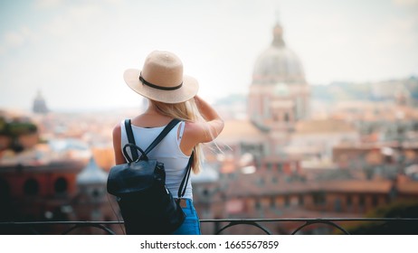 Rome Europe Italy travel summer tourism holiday vacation background - young smiling girl with mobile phone camera and map in hand standing on the hill looking on the cathedral Vatican - Shutterstock ID 1665567859
