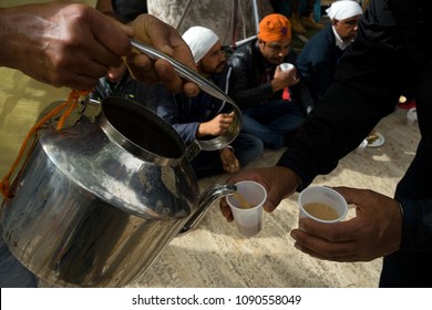 Rome, Italy, 04/15/2018:  a man pours indian tea (chai) during the celebrations of Nagar Kirtan. Nagar Kirtan is a religious procession that takes place wherever there are Sikh during april.
