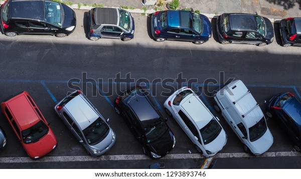 Rome /\
Italy - 07 02 2018: Capital of Italy. The street in Rome is full of\
cars. The problem of parking places. Lack of parking space.\
Carelessly parked cars. Traffic problems. Top\
view