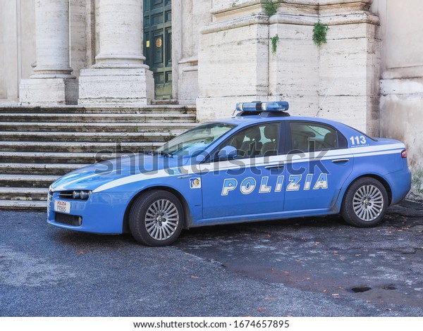 Rome, Italy - 11 26 2018: Police car in city\
center of Rome. Blue Alfa Romeo, vehicle stands on the asphalt next\
to stairs to the church. Polizia di Stato is one of the national\
police force of Italy.
