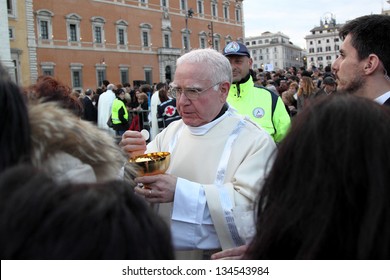 ROME, ITALY - April 07: A priest distributes the communion to the crowd giving hosts, during the mass of Pope Francis for the settlement in Archbasilica of St. John Lateran on April 07, 2013 in Rome.