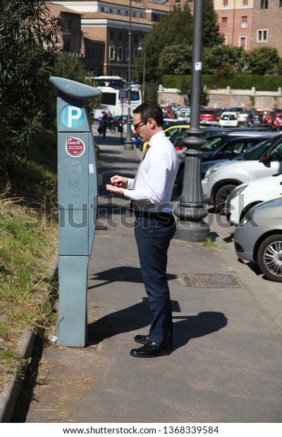 Rome / Italy - April 12 2016: Italian man paying\
for parking in car park in\
Rome.