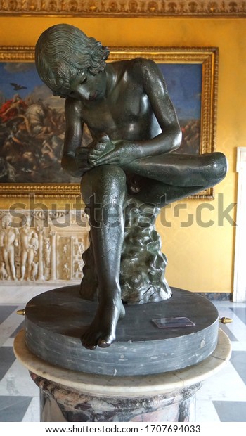 Rome, Italy - April 2018 : The Spinario which is a\
Greco-Roman Hellenistic bronze sculpture of a boy withdrawing a\
thorn from the sole of his foot in Palazzo dei Conservatori, Musei\
capitolini, Rome.
