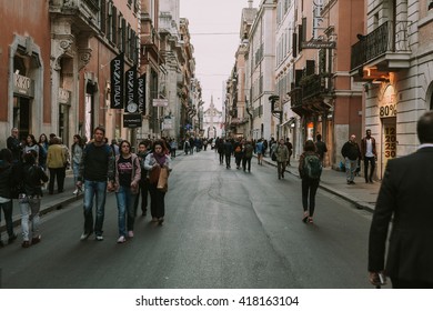 ROME, ITALY - APRIL 21 2016: People Walking In Via Del Corso On April 21, 2016 In Rome, Italy. Via Del Corso Is A Popular Shopping Street In Rome City Center.