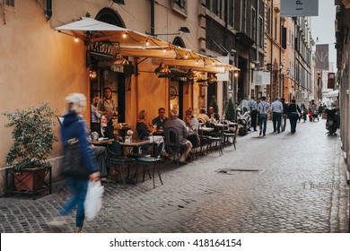 ROME, ITALY - APRIL 21 2016:Tourists In A Charming Restaurant Terrace In The City Center Of Rome On April 21, 2016 In Rome, Italy. Rome Has A Lot Of Restaurants Where People Enjoy The Italian Dishes.