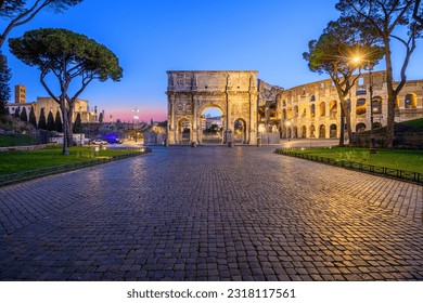 Rome, Italy at the Arch of Constantine and the Colosseum at twilight.